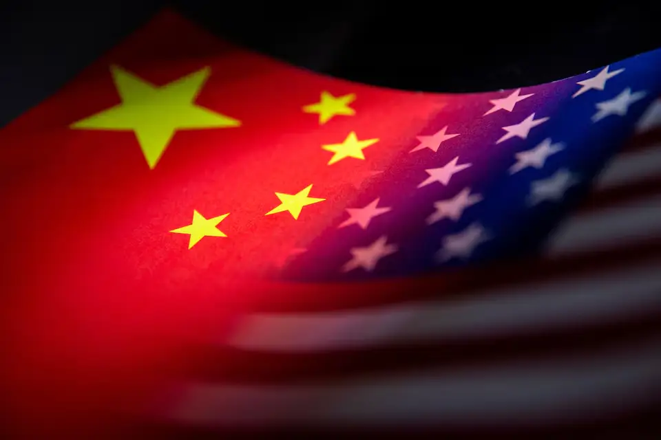 Chinese and American flags printed on white paper, symbolizing diplomatic relations and international tensions.