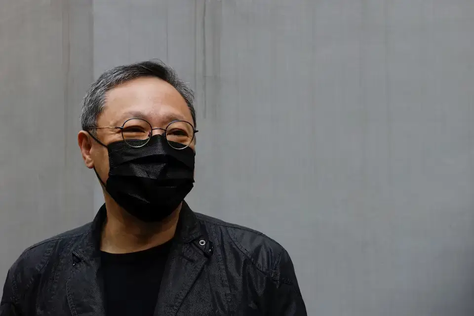 Pro-democracy activist Benny Tai arrives at a police station in Hong Kong over national security law charges.