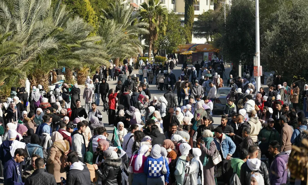 Syrian students walk across the campus of Damascus University during a moment of calm on December 15.