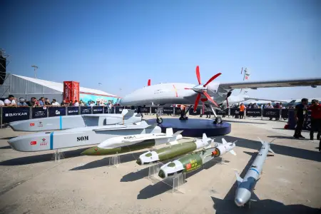 A display of Turkish defense technologies, including advanced drones and missiles, showcased at an aerospace event.