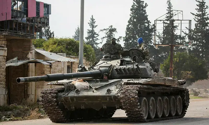 HTS-led rebels drive a military vehicle in al-Rashideen, Aleppo province, highlighting their ongoing offensive efforts.