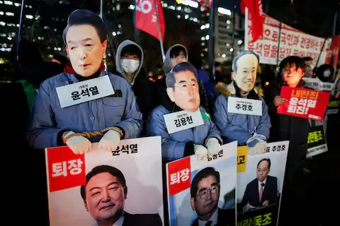 Protesters wearing satirical masks of Yoon Suk Yeol and top officials at Seoul National Assembly impeachment protest.