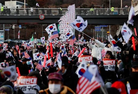 Protesters gather outside the official residence of impeached South Korean President Yoon Suk Yeol, opposing his arrest warrant.