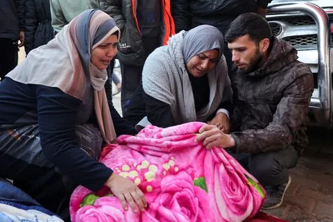  Mourners gather at a funeral for Palestinians killed in Israeli airstrikes, held at Al-Aqsa Martyrs Hospital in Deir Al-Balah.