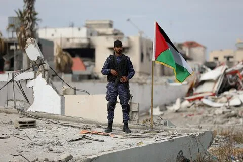  A Hamas policeman guards the destroyed Hamas police headquarters in Gaza City after the Israel-Hamas ceasefire, January 22, 2025.