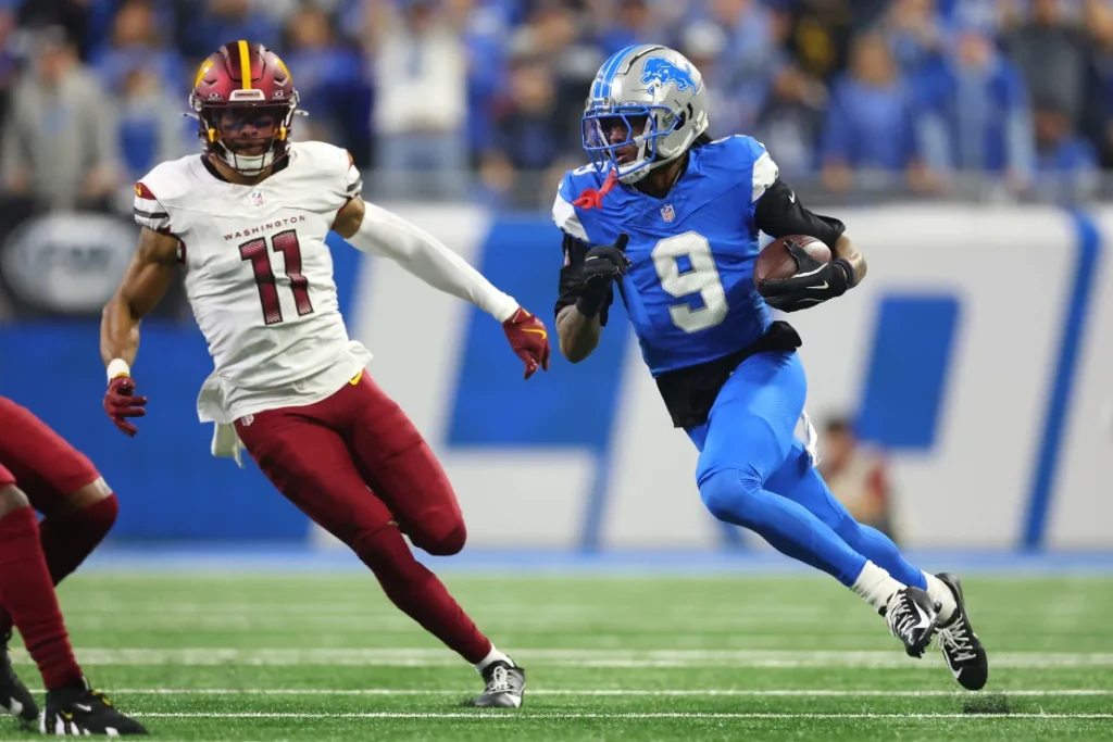 In the second quarter of the NFC Divisional Playoffs, Jameson Williams (#9) of the Detroit Lions runs the ball for a score against the Washington Commanders.