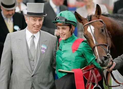 French jockey Christophe Soumillon celebrates with horse owner H.H. Aga Khan after winning the Queen Anne Stakes on Valixir at Royal Ascot, June 14, 2005.